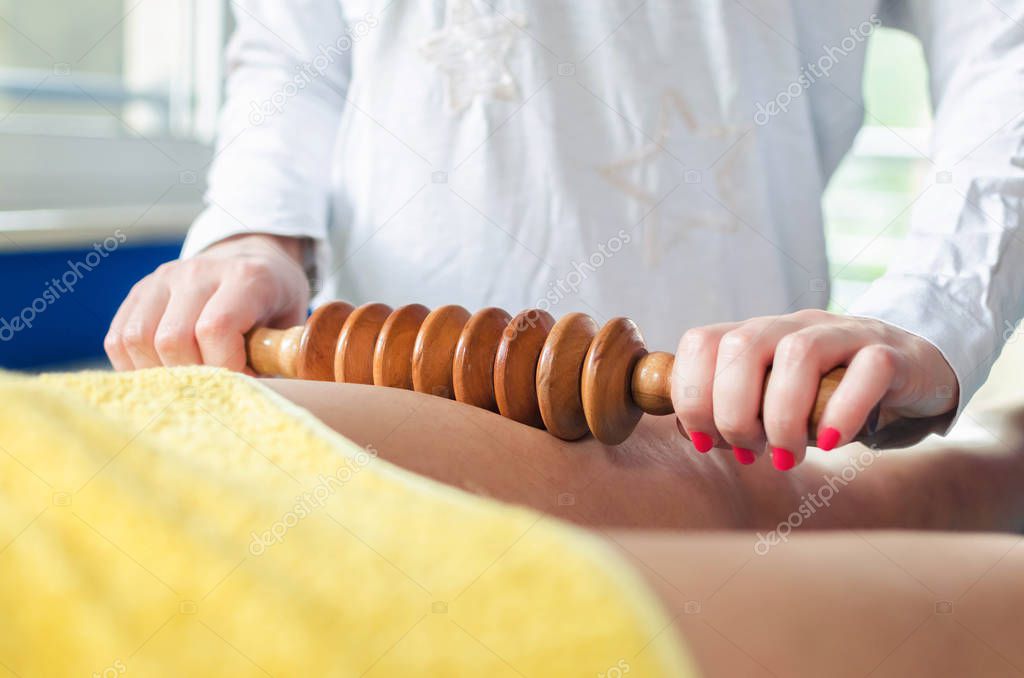 Close up of woman on maderotherapy anticellulite massage treatment at beauty spa salon.