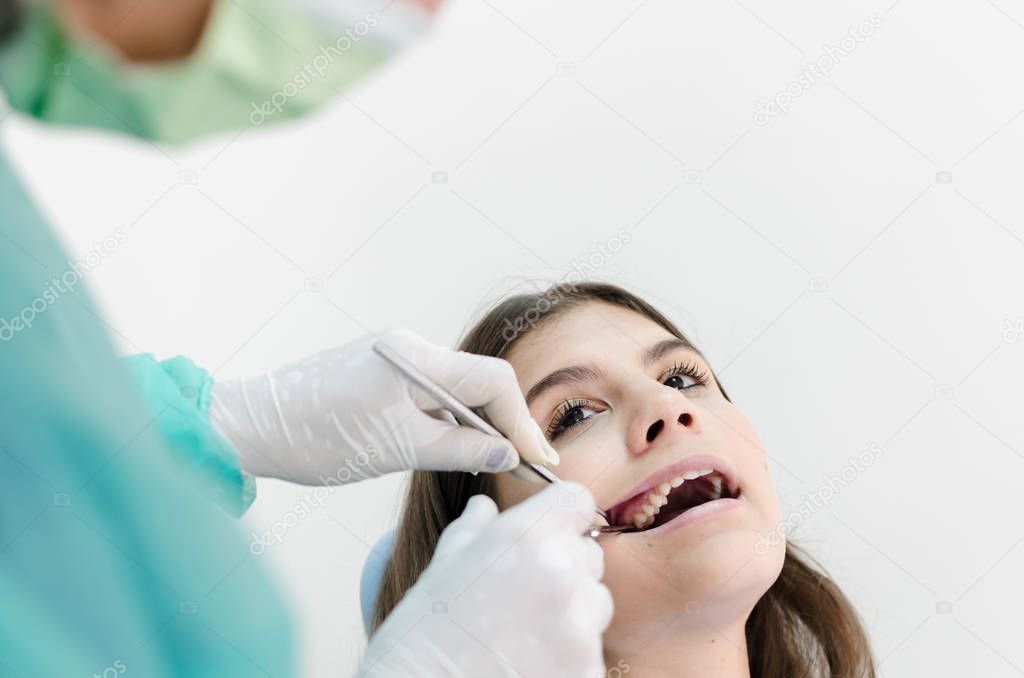 Medical treatment at the dentist office, tooth removing. Space for text.