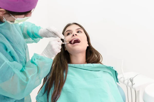 女性経験豊富な歯医者が患者の歯を削除します テキストのためのスペース — ストック写真