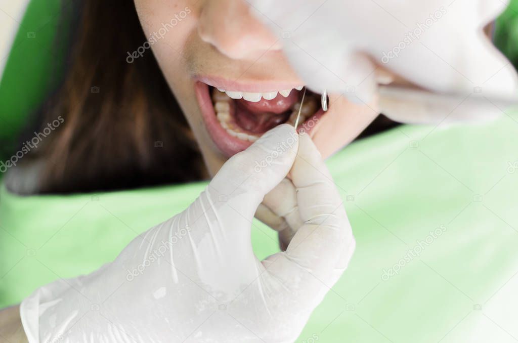 Close up of female patient during teeth devitalization at dentist office. Space for text.