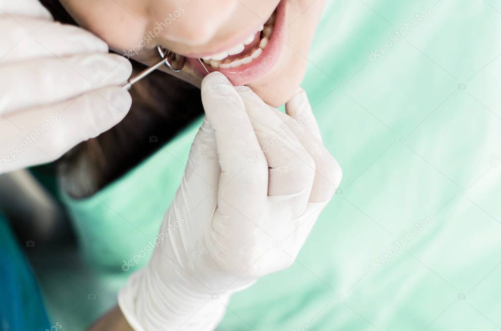 Close up of patient during teeth devitalization at dentist office. Space for text.