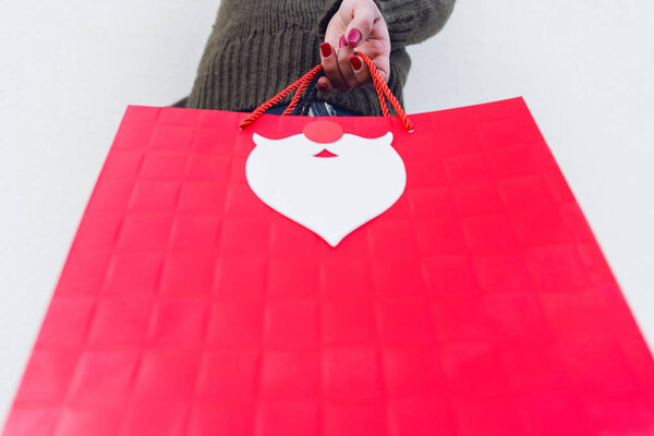 Bottom view of woman holding red shopping bag