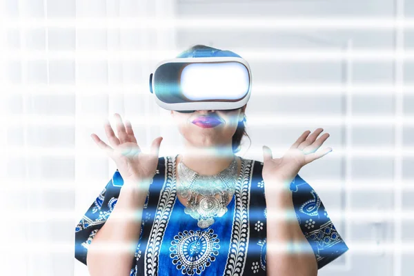 Indian woman using wearable virtual reality headset