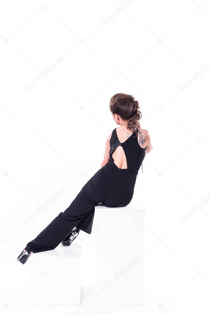 Stylish young model in black clothes posing on white background