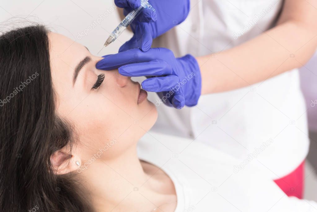 Portrait of female patient having modern noninvasive procedure of rhinoplasty