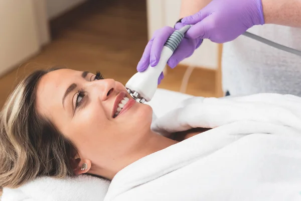 Woman in beauty center having multipolar radiofrequncy treatment for her facial skincare