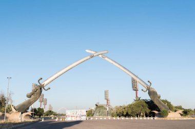 Baghdad, Iraq - July 15, 2019: Hands of Victory or the Crossed Swords. Monument to fallen soldiers in Iraq clipart