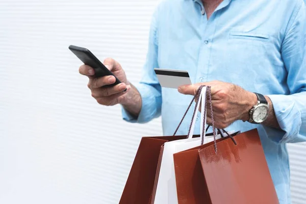 Midsection Man Holding Shopping Bags Using Mobile Phone Credit Card — Stock Photo, Image