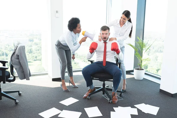 Two Female Colleagues Encouraging Man Win Office Battle Royalty Free Stock Photos