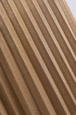 Pilili etek altın. Soyut ayrıntı. Görünümü kapatın. Güzel arka plan. Dikey görüntü.