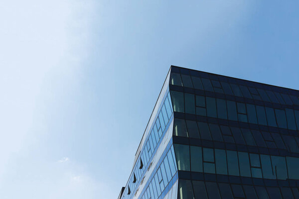Modern glass business center building with blue sky on the background. Copy space.