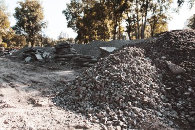 Yeni bir şey inşa etmek için eski parkı yok etti. Küçük taş yığını ve kırık beton bıçakları. İnşaatın başlangıcı. İnşaat malzemeleri ve ezilmiş taş.