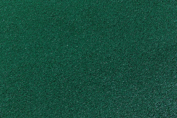 Painted rubber crumb surface. Rough colorful background. Green polyurethane material example. Copy space.