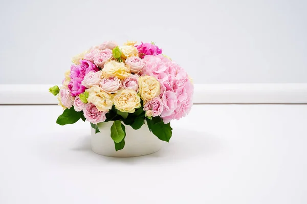 Beautiful colorful flowers bouquet on the white background. Bouquet made of peonies and different roses. Wedding flowers. Copy space for advert. Valentine\'s or Women\'s Day.