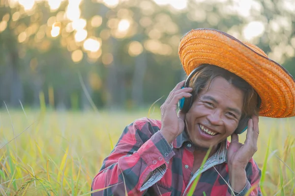 Happy  Farmer Listen to music with head phone.