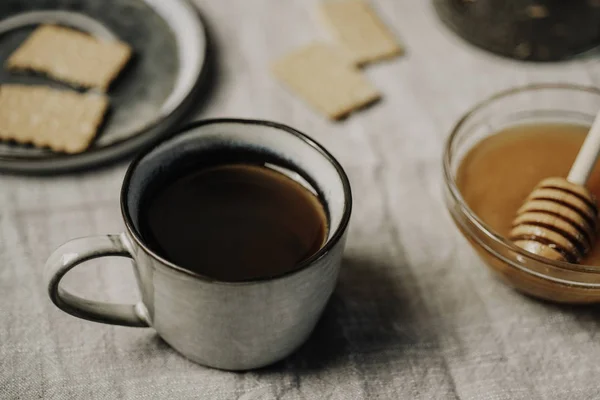 cozy seasonal fall or winter breakfast with hot drink honey and biscuits cookies over tablecloth