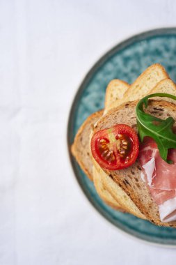 Lezzetli taze adet ekmek ham domates ve roket salata plat beyaz arka plan üzerinde üzerinde 