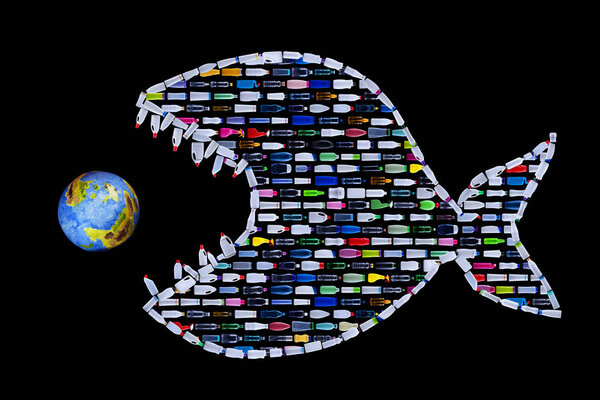 Garbage destroying our world oceans and earth - plastic bottles arranged in lines forming a predatory fish catching and eating the planet, ecologic disaster concept