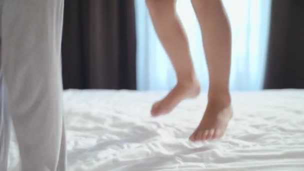 Щасливі діти стрибають батьки ліжко вранці — стокове відео