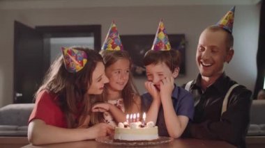 Çocuk yapar A dilek ve darbeler mum bir Doğum günü pastası