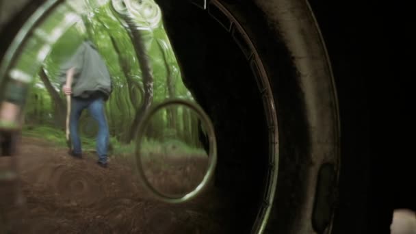 Spiegelbild eines professionellen Holzfällers, der mit Axt in wildem Laubwald spaziert. — Stockvideo