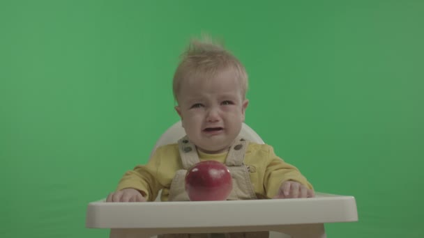 Gelukkige baby met plezier en spelen met Apple. — Stockvideo