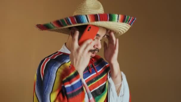 Joven mexicano en poncho multicolor y sombrero. — Vídeos de Stock