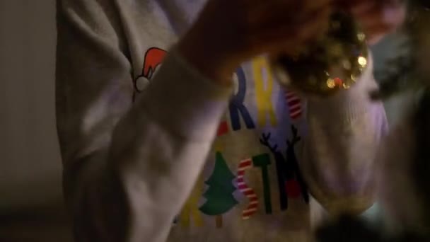 New Year. Boy Takes Off The Christmas Tree Decoration. — Stock Video