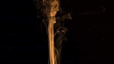 Siyah Arkaplanda Duman. Işık, turuncu gibi görünen dumanı aydınlatır..