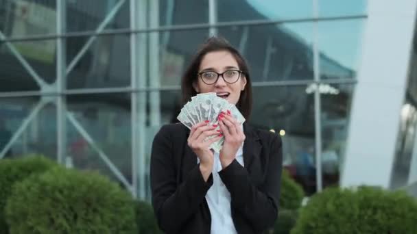 Mladá obchodní dáma drží peníze ve svých rukou. — Stock video