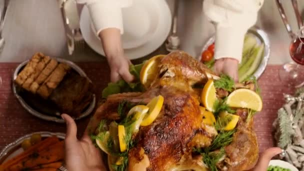 Святковий стіл. Жіночі руки покладіть смажену курку на стіл. різдвяні страви — стокове відео