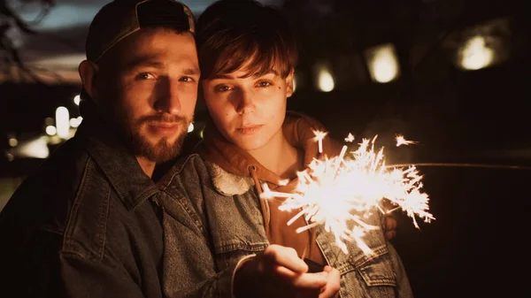 หนุ่มสาว คู่ กับ Sparklers กลางแจ้ง ตอน กลางคืน . — ภาพถ่ายสต็อก