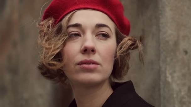 Wanita muda misterius dengan rambut keriting pendek di baret merah. — Stok Video