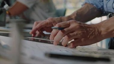 While engaged in digital design, my hands are focused on the tablet and sketches within an inspiring workspace