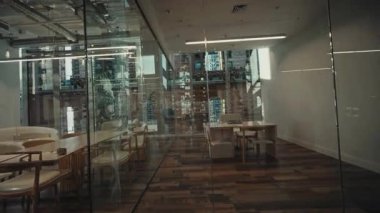 A stylish glasswalled office that showcases a sleek and modern design while providing an inviting workspace atmosphere