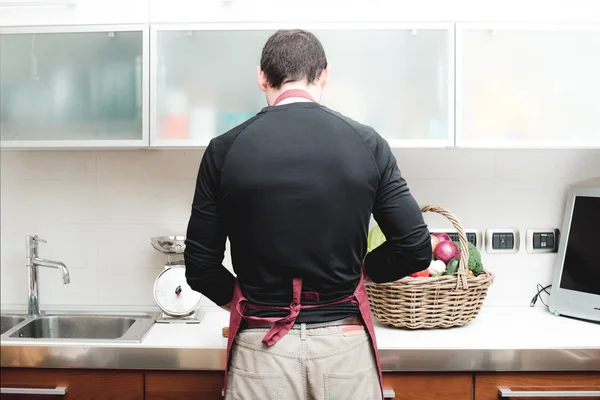 man prepare vegetables over the bench in the kitchen