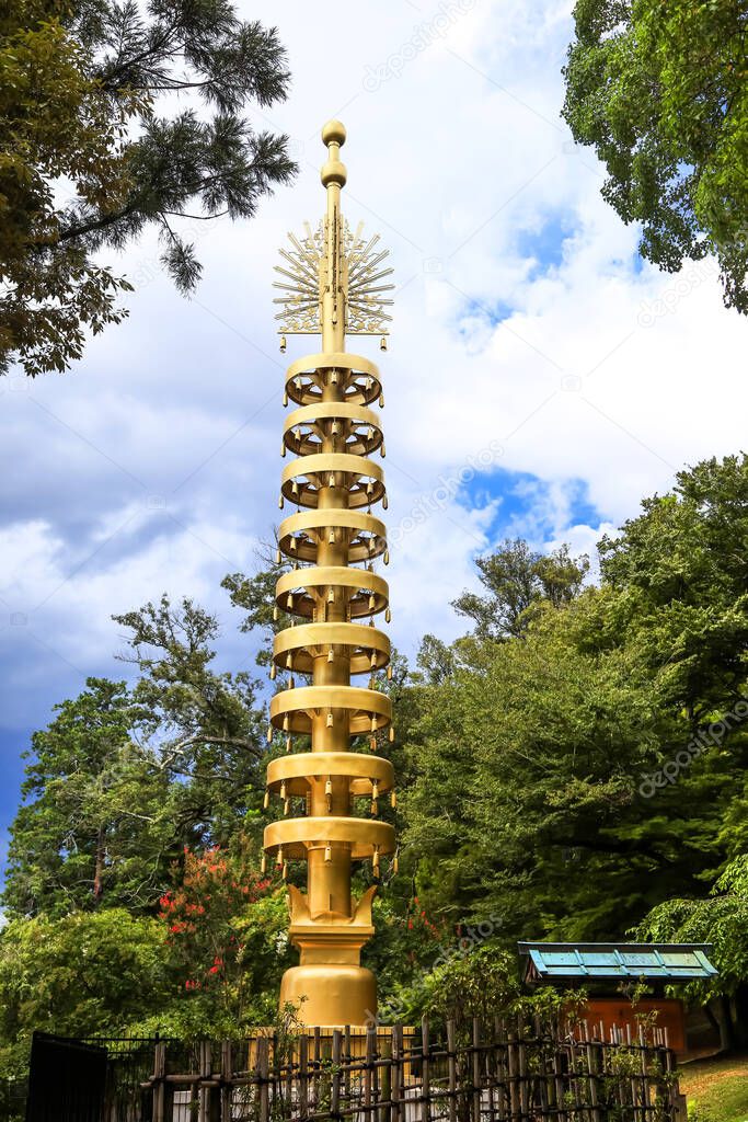 Tall golden monument in Nara park, Japan