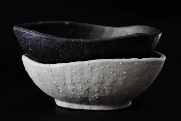 a black and white bowl and a white bowl