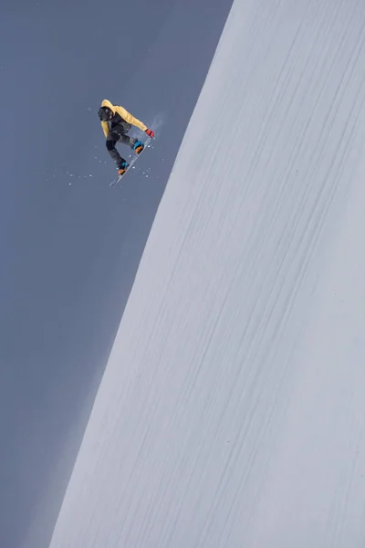 Repülő snowboardos a hegyekben. Extrém téli sport. — Stock Fotó
