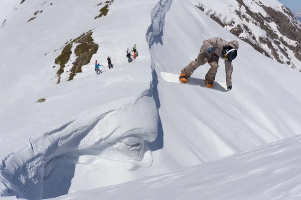 Karlı yamaçta uçan snowboardcu. Kış sporları, snowboard sporları. — Stok fotoğraf