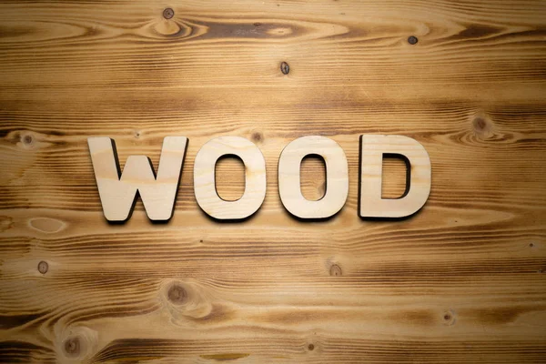WOOD word made with building blocks on wooden board.