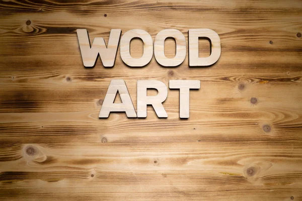 WOOD ART words made of wooden letters on wooden board.