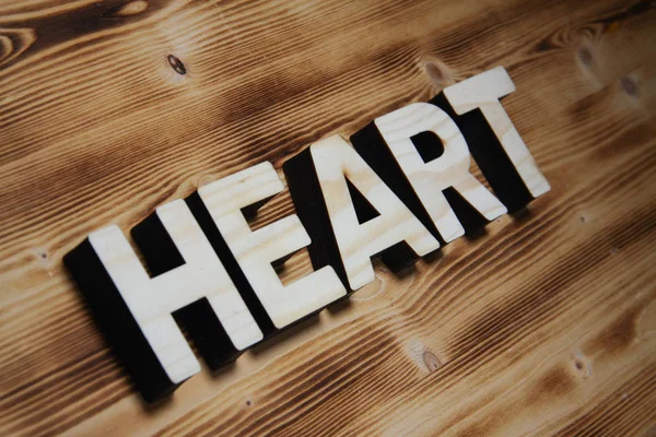 HEART word made with building blocks on wooden board — Stock Photo, Image