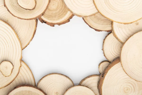 Pine tree cross-sections with annual rings on white background. Lumber piece close-up, top view. — Stock Photo, Image