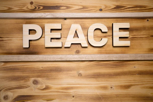 PEACE word made with building blocks on wooden board — Stock Photo, Image