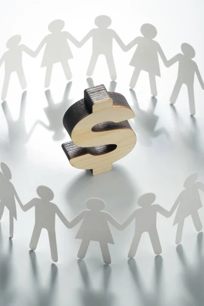 Circle of paper people holding hands in front of big dollar sign. Consumerism, economy concept.