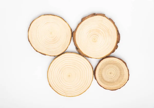 Pine tree cross-sections with annual rings on white background. Lumber piece close-up, top view. — Stock Photo, Image