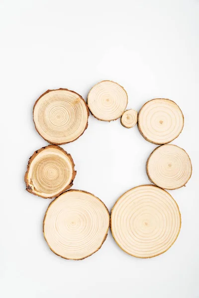 Pine tree cross-sections with annual rings on white background. Lumber piece close-up, top view. — Stock Photo, Image