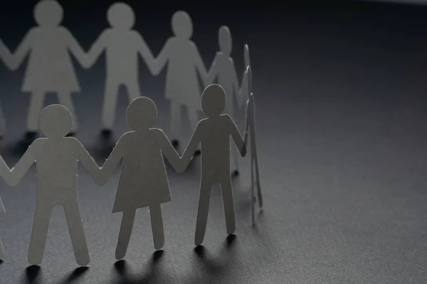 Circle of paper people holding hands on dark surface. Community, union concept. Society and support. — Stock Photo, Image