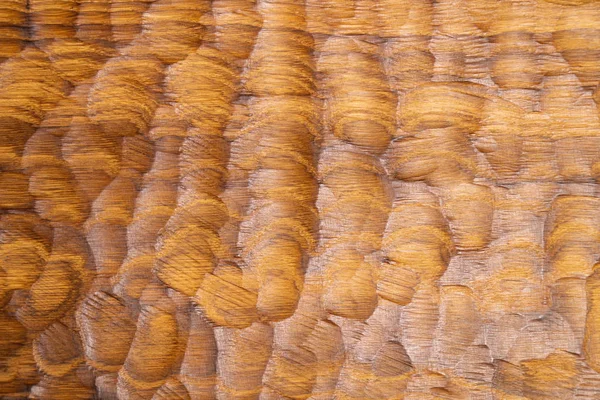 Carved wood waves texture, background. Carved wooden surface for abstract background. Wooden cutting board surface.